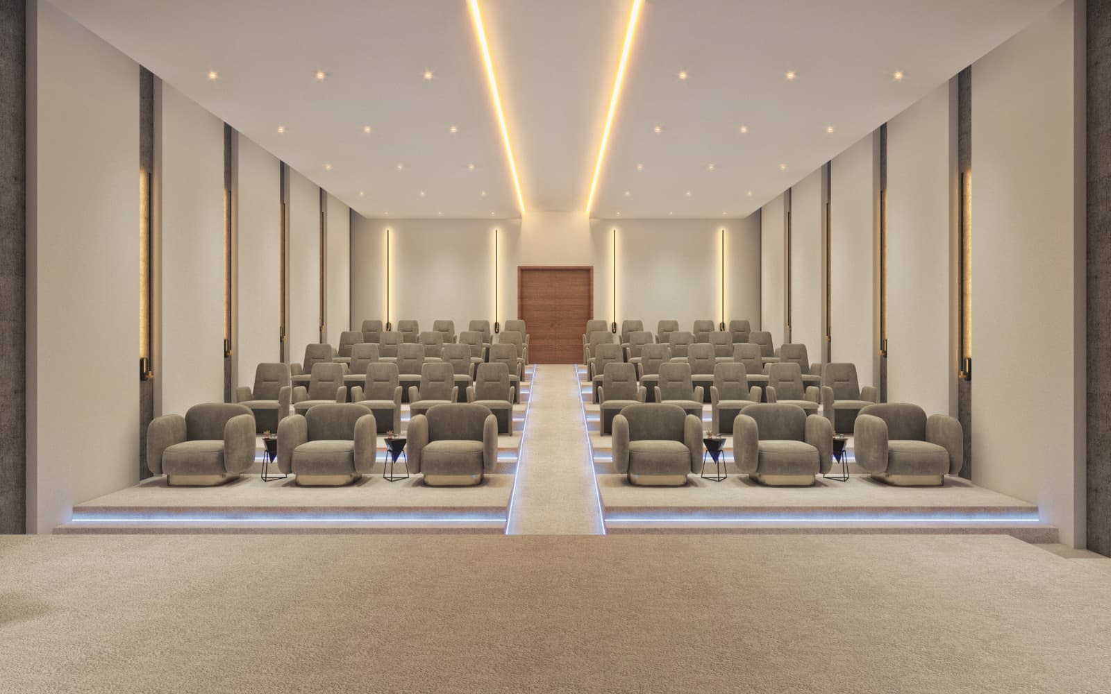 Raked auditorium in cream: fixed upholstered seating either side of a central aisle, cove-lit ceiling and a timber stage door