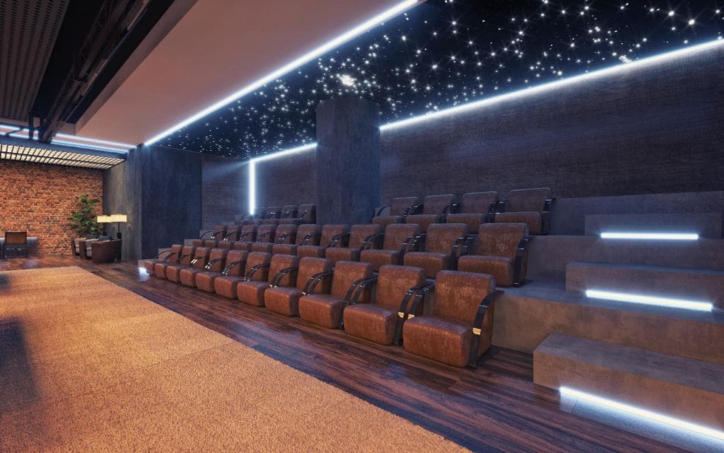Private cinema with tiered leather recliners, LED step and wall lighting, an exposed brick side wall and a fibre-optic star ceiling