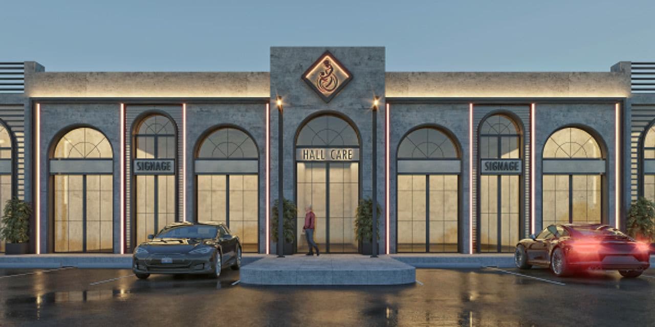 Arcaded commercial facade at dusk: stone piers, arched glazing, neon reveals, blank signage panels and a lit entrance portal