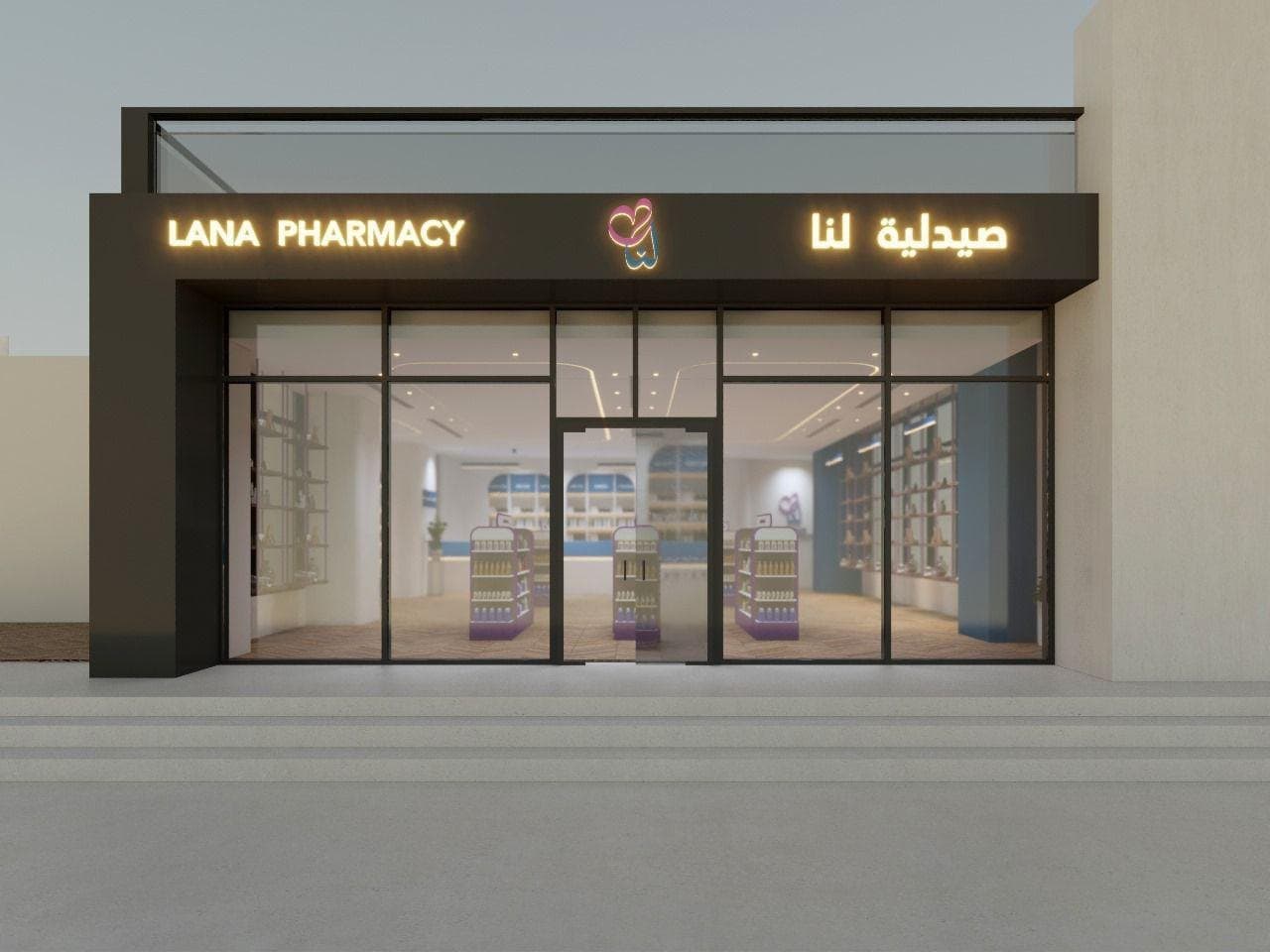 Pharmacy shopfront elevation: illuminated channel-letter signage in Arabic and English on one fascia, fitted shelving visible through full-height glazing