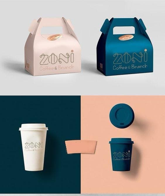 Brand identity applied to takeaway packaging: printed gable boxes and hot cups in a two-colour scheme, shot as a flat-lay set