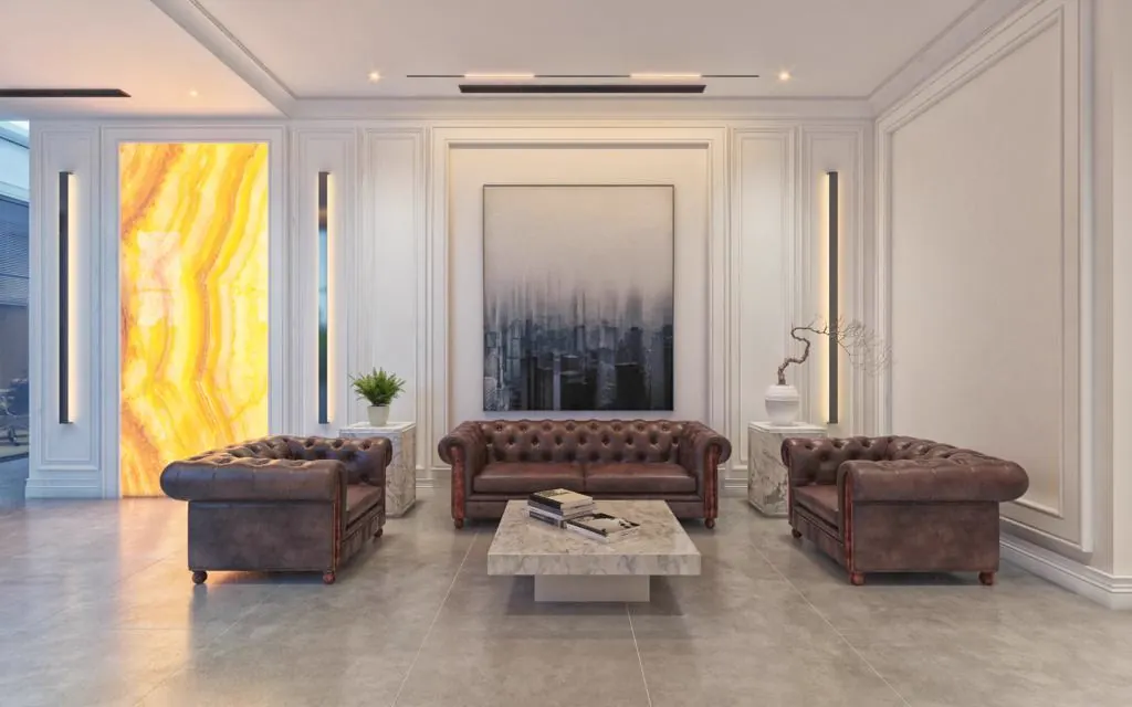 Reception lounge with leather chesterfield sofas against onyx panelling