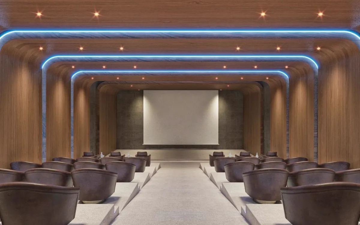 Auditorium with tiered seating under blue cove lighting