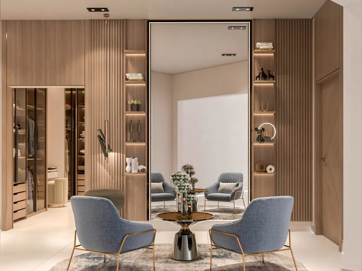 Wardrobe joinery beside a seating area with blue chairs